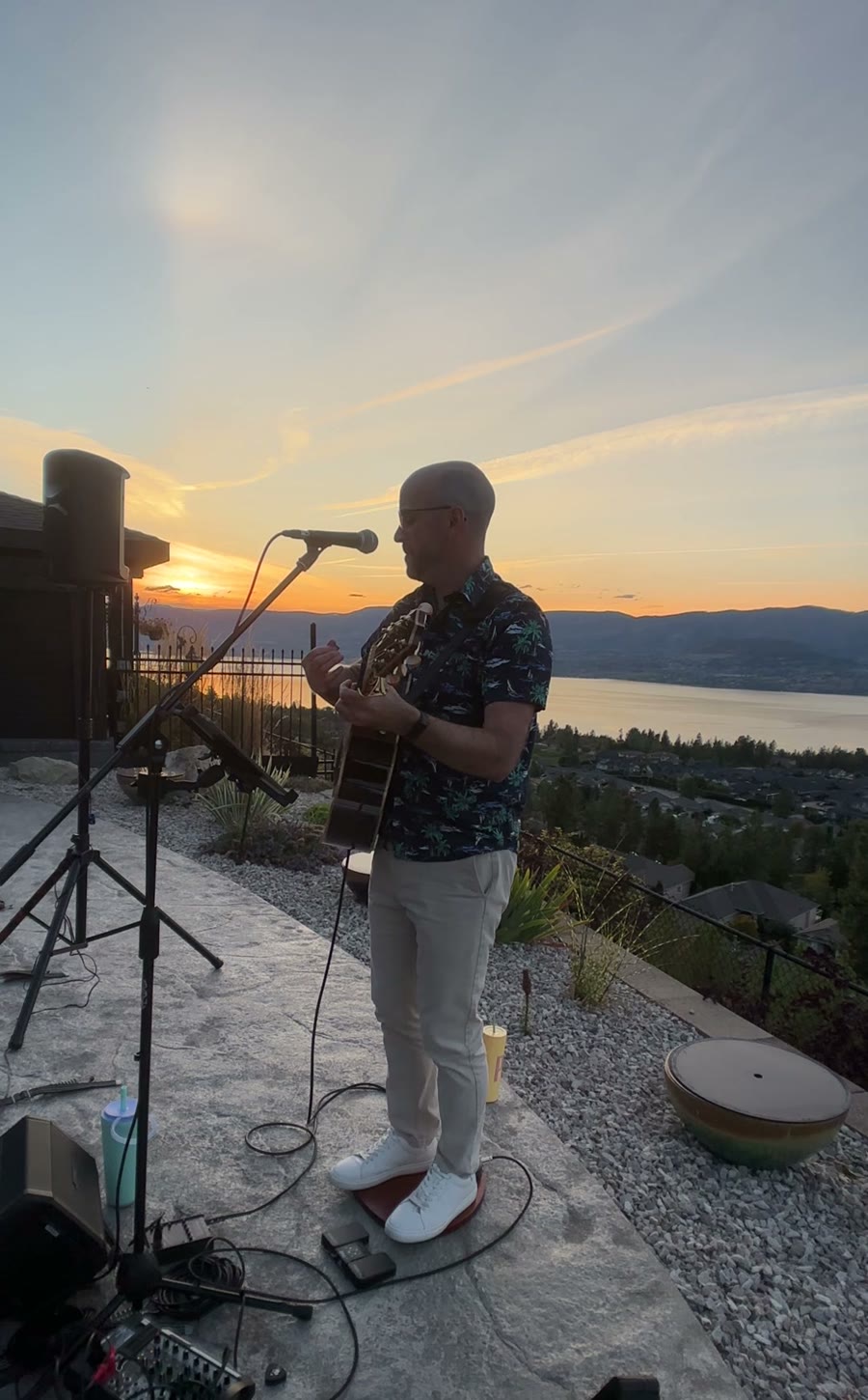 Colin singing at sunset on a terrace above Okanagan Lake